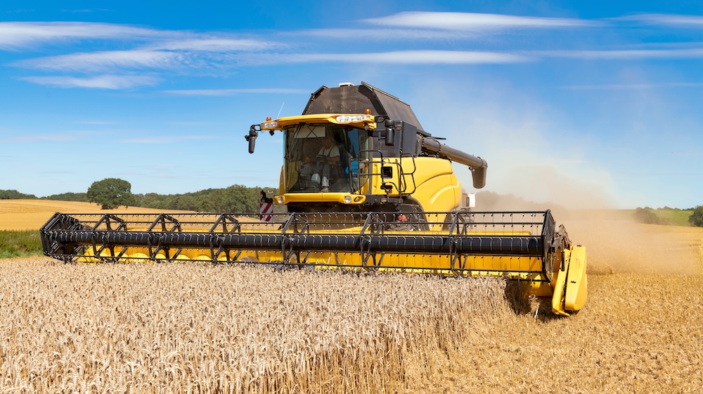 Combine harvester at the grain harvest in the field – 1897