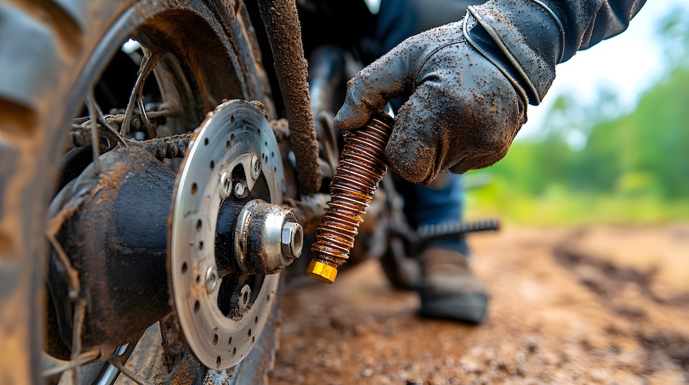 Applying Anti-Seize Compound to a Motorcycle Exhaust Bolt to Prevent Corrosion