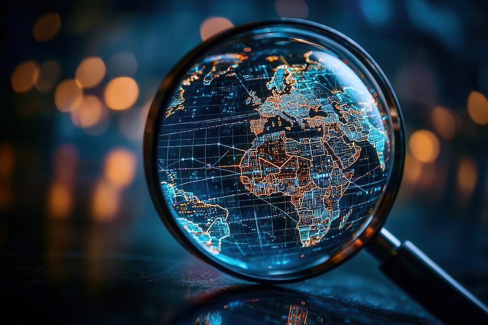 A magnifying glass focuses on a glowing, high-tech globe, symbolizing exploration and global connectivity in a digital age.