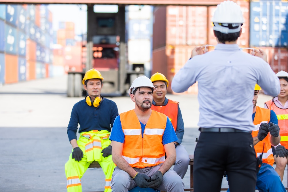 foreman is teaching and training workers how to wear face masks and take care of themselves while the coronavirus is spread.